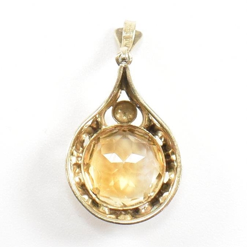 295 - A 333 gold and citrine necklace pendant. Weight 2.3g. Measures 3cm. All weights, measurements and si... 