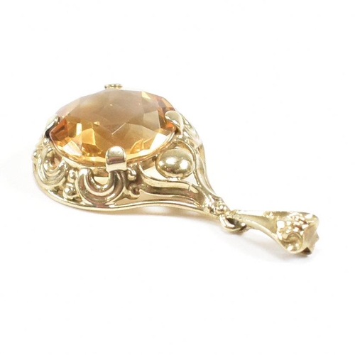 295 - A 333 gold and citrine necklace pendant. Weight 2.3g. Measures 3cm. All weights, measurements and si... 