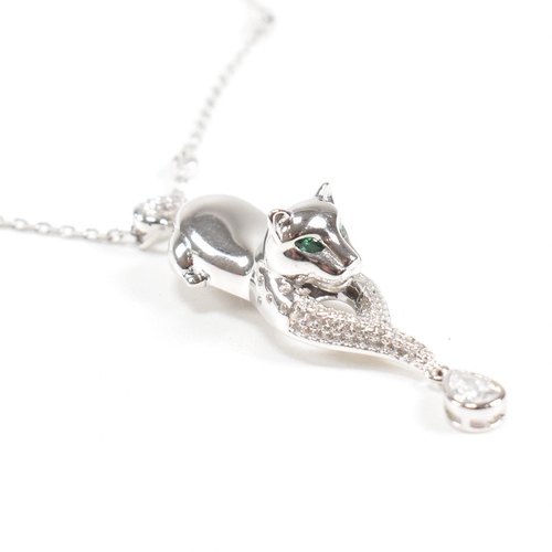 302 - A contemporary white metal cat pendant necklace set with emerald eyes. Chain stamped 925. Weight app... 