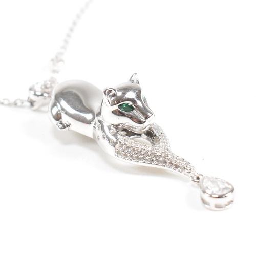 302 - A contemporary white metal cat pendant necklace set with emerald eyes. Chain stamped 925. Weight app... 