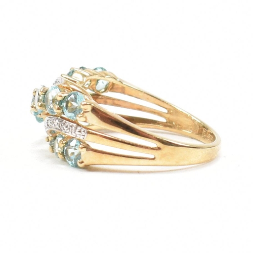 32 - A hallmarked 9ct gold aquamarine and diamond crossover ring. Weight 3.4g. Size O. All weights, measu... 