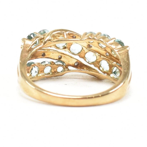 32 - A hallmarked 9ct gold aquamarine and diamond crossover ring. Weight 3.4g. Size O. All weights, measu... 