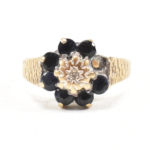 324 - A hallmarked 9ct gold sapphire and diamond cluster ring. The ring having one stone missing. Hallmark... 