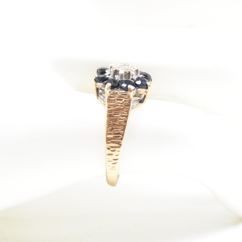 324 - A hallmarked 9ct gold sapphire and diamond cluster ring. The ring having one stone missing. Hallmark... 