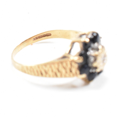 324 - A hallmarked 9ct gold sapphire and diamond cluster ring. The ring having one stone missing. Hallmark... 