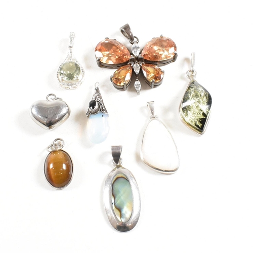 330 - A selection of gem set necklace pendants. The pendants to include butterfly heart abalone, mother of... 