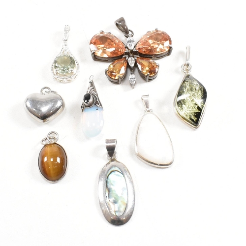 330 - A selection of gem set necklace pendants. The pendants to include butterfly heart abalone, mother of... 