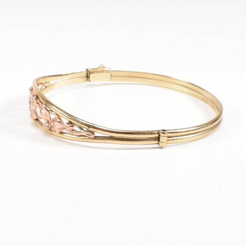 35 - A hallmarked 9ct gold Clogau 'Tree of life' bangle with floral mounted head. Total weight 5.4g. Meas... 