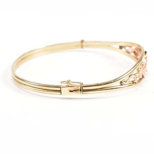 35 - A hallmarked 9ct gold Clogau 'Tree of life' bangle with floral mounted head. Total weight 5.4g. Meas... 