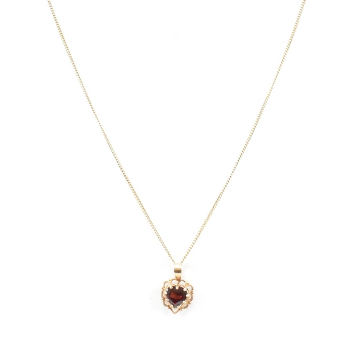 371 - A gold and garnet pendant necklace. The necklace strung with a  garnet set on a fine link chain. Cha... 