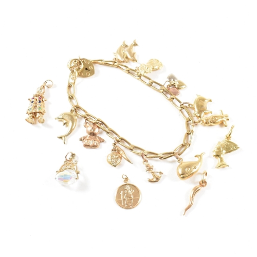 372 - A gold charm bracelet. The bracelet hallmarked to the jump ring and strung with yellow metal and gol... 