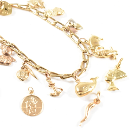 372 - A gold charm bracelet. The bracelet hallmarked to the jump ring and strung with yellow metal and gol... 