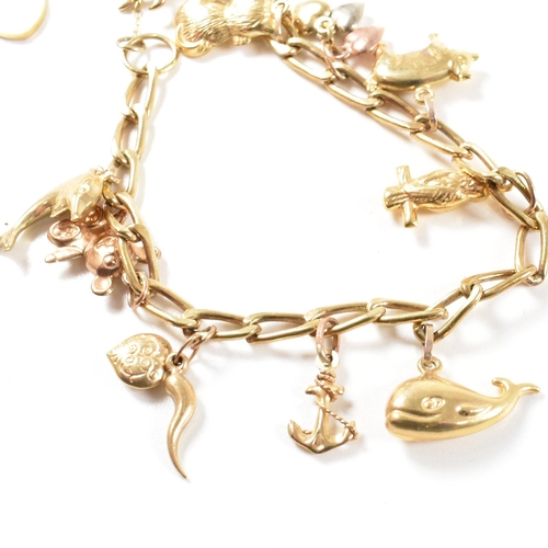 372 - A gold charm bracelet. The bracelet hallmarked to the jump ring and strung with yellow metal and gol... 