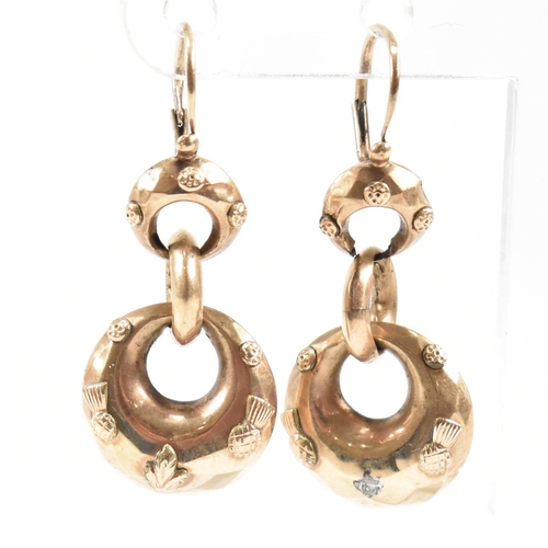 373 - A pair of 19th century pendant earrings. The earrings formed with three graduated hoops with partial... 