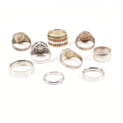 386 - A collection of 925 silver rings.The rings to include pierced, puzzle, dragonfly 18ct gold overlay, ... 