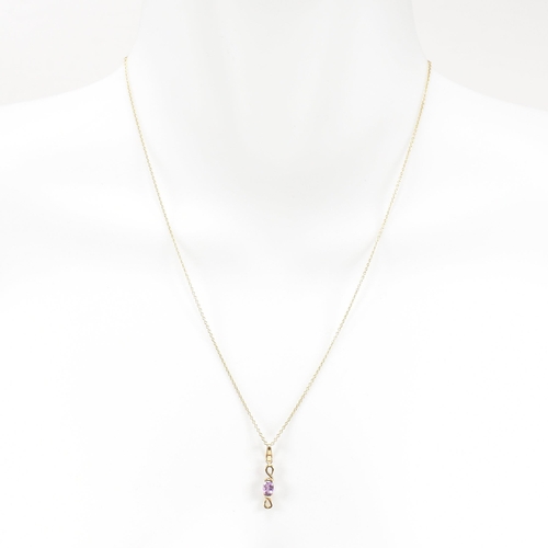 387 - A hallmarked 9ct gold pendant necklace. The necklace strung with an amethyst pendant on a fine link ... 