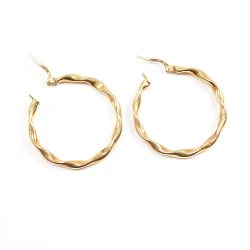 389 - Two pairs of 9ct gold earrings.  A pair of large twisted hoop earrings marked 375, 2.8cm. A pair of ... 