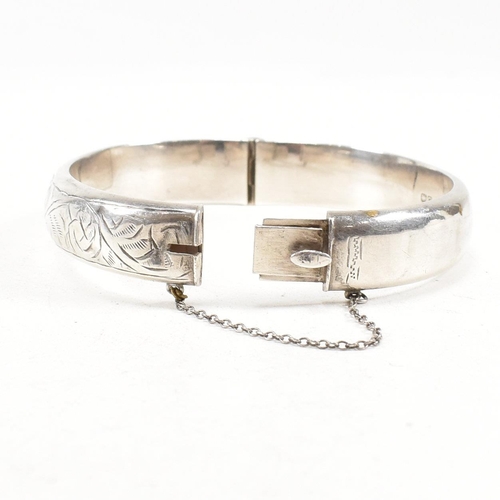 391 - Two hallmarked 925 silver hinged bangles. The bangles to include etched foliate decorated bangle, ha... 