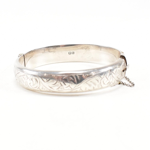 391 - Two hallmarked 925 silver hinged bangles. The bangles to include etched foliate decorated bangle, ha... 