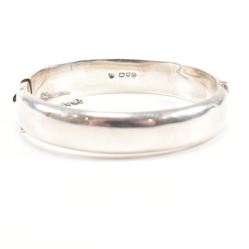 391 - Two hallmarked 925 silver hinged bangles. The bangles to include etched foliate decorated bangle, ha... 