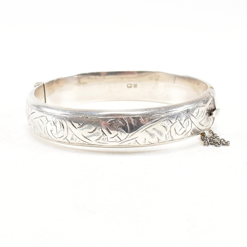 391 - Two hallmarked 925 silver hinged bangles. The bangles to include etched foliate decorated bangle, ha... 