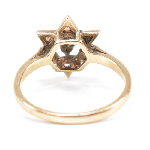 394 - A hallmarked 9ct gold garnet star cluster ring. 2.3g. Size M.5. All weights, measurements and sizes ... 