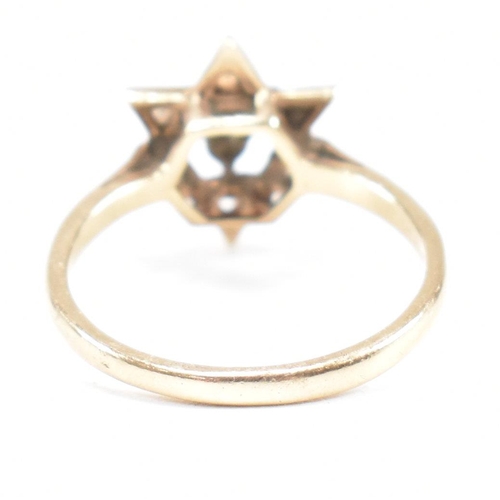 394 - A hallmarked 9ct gold garnet star cluster ring. 2.3g. Size M.5. All weights, measurements and sizes ... 