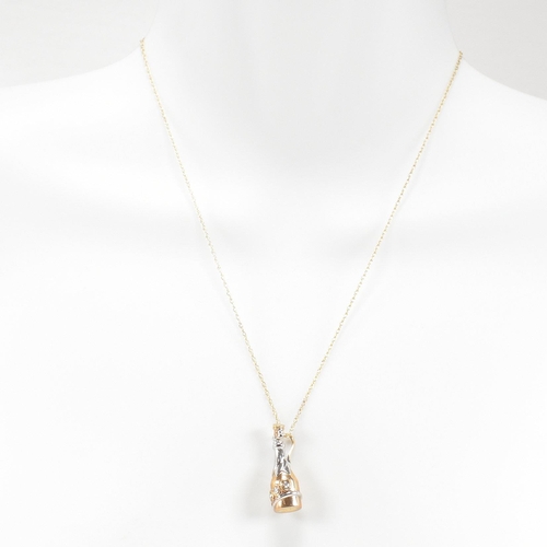 397 - A hallmarked 9ct gold and diamond millennium pendant necklace. The necklace strung with a diamond se... 