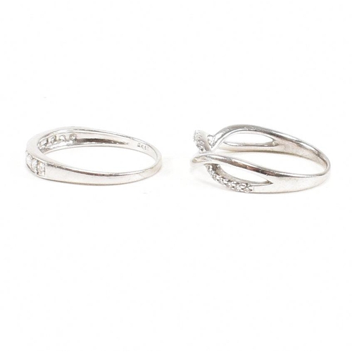 40 - Two hallmarked 9ct white gold and diamond rings. A half eternity ring and diamond set swirl ring. We... 