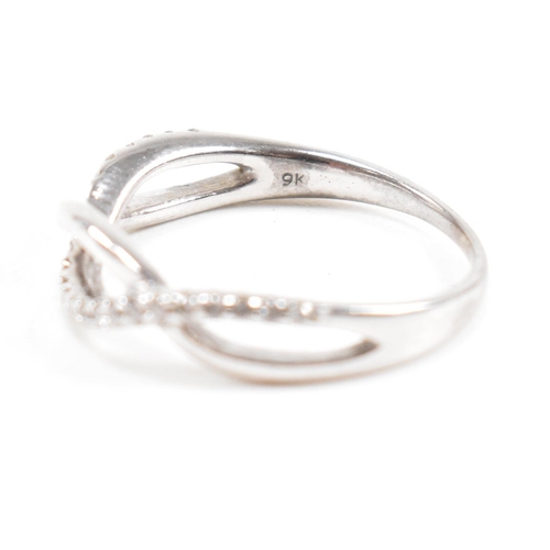 40 - Two hallmarked 9ct white gold and diamond rings. A half eternity ring and diamond set swirl ring. We... 