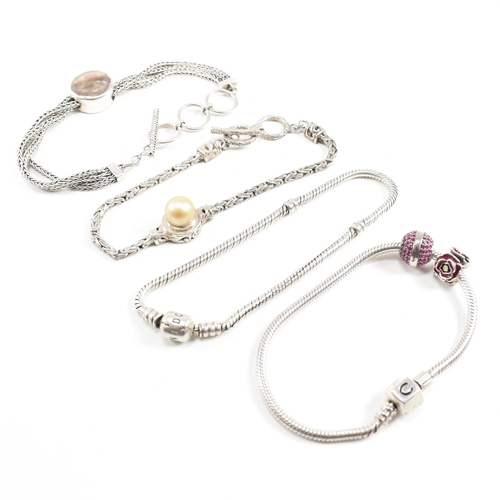 404 - Four 925 silver bracelets. A hallmarked Chamilia bracelet with rose and pink ball charm. A Pandora b... 