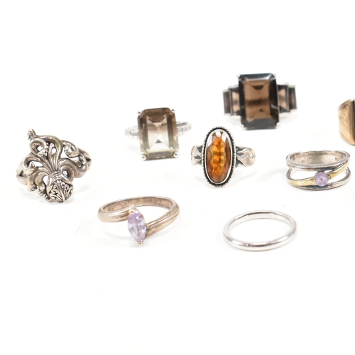 406 - A collection of 925 silver and gem set rings. The rings to include smoky quartz, hematite, paste, ba... 