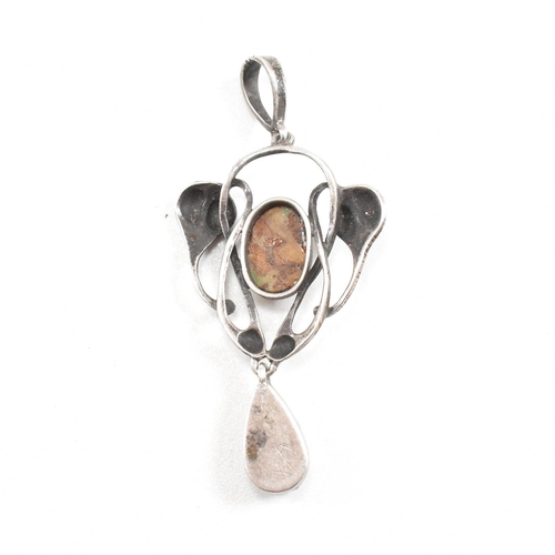 41 - An Arts and Crafts silver opal and mother of pearl necklace pendant.  The pendant having a mother of... 