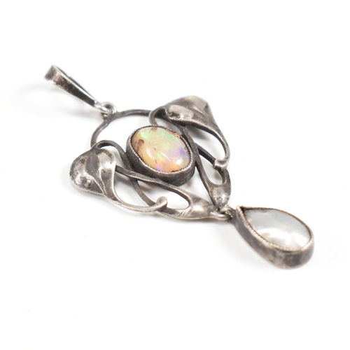 41 - An Arts and Crafts silver opal and mother of pearl necklace pendant.  The pendant having a mother of... 