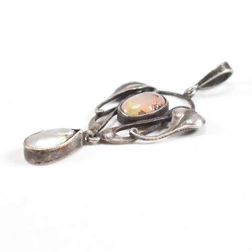 41 - An Arts and Crafts silver opal and mother of pearl necklace pendant.  The pendant having a mother of... 