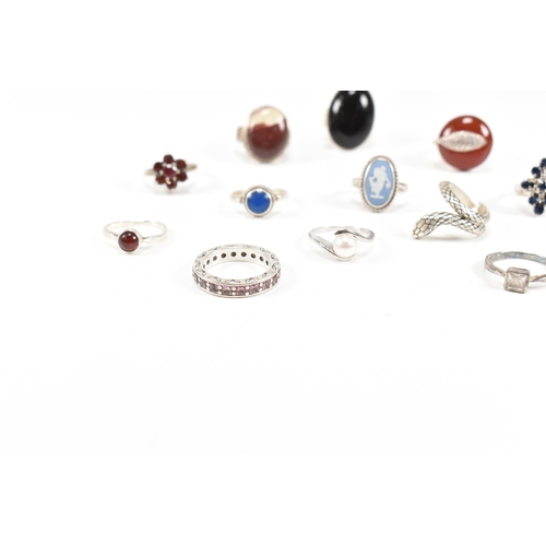 410 - A collection of 12 silver rings. The rings to include carnelian, onyx, CZ, jasperware sapphire, pear... 