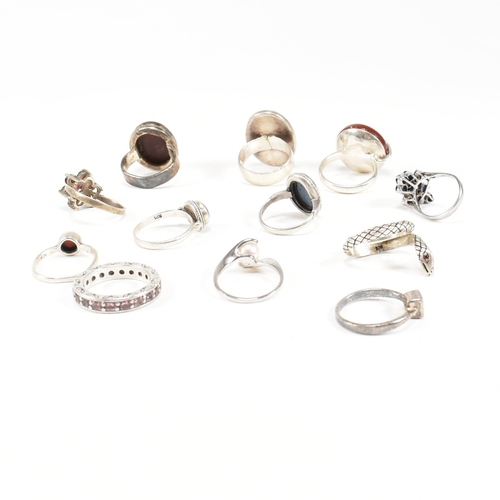 410 - A collection of 12 silver rings. The rings to include carnelian, onyx, CZ, jasperware sapphire, pear... 