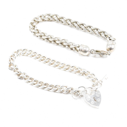 415 - Two 925 silver bracelets. A chunky curb link chain with a padlock clasp marked 925, 18cm.  A ribbed ... 