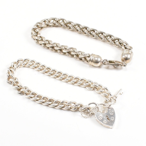 415 - Two 925 silver bracelets. A chunky curb link chain with a padlock clasp marked 925, 18cm.  A ribbed ... 