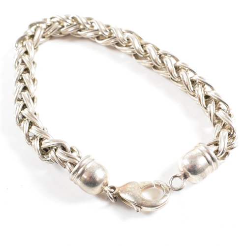 415 - Two 925 silver bracelets. A chunky curb link chain with a padlock clasp marked 925, 18cm.  A ribbed ... 