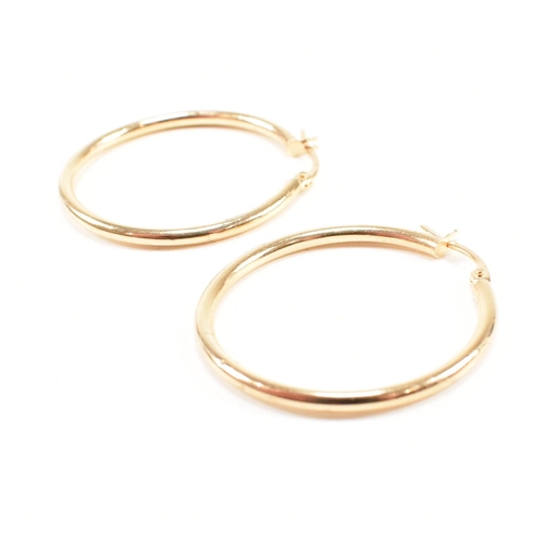 425 - Three pairs of 9ct gold earrings. The earrings to include a large pair of tube hoop earrings, 3cm, m... 