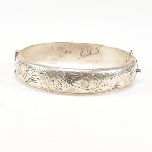 426 - A hallmarked 1970s silver hinged bangle. Monogram inscribed to interior of the band. Weight 20g. Mea... 