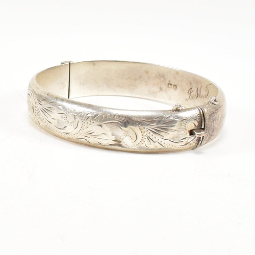 426 - A hallmarked 1970s silver hinged bangle. Monogram inscribed to interior of the band. Weight 20g. Mea... 