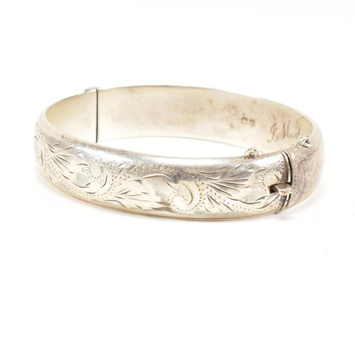 426 - A hallmarked 1970s silver hinged bangle. Monogram inscribed to interior of the band. Weight 20g. Mea... 