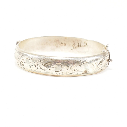 426 - A hallmarked 1970s silver hinged bangle. Monogram inscribed to interior of the band. Weight 20g. Mea... 