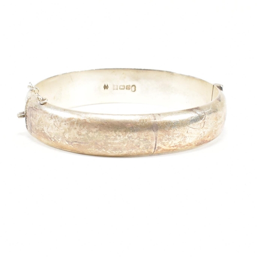 426 - A hallmarked 1970s silver hinged bangle. Monogram inscribed to interior of the band. Weight 20g. Mea... 