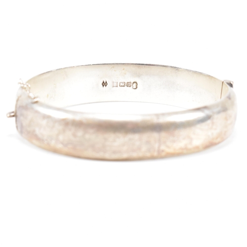 426 - A hallmarked 1970s silver hinged bangle. Monogram inscribed to interior of the band. Weight 20g. Mea... 