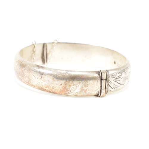 426 - A hallmarked 1970s silver hinged bangle. Monogram inscribed to interior of the band. Weight 20g. Mea... 