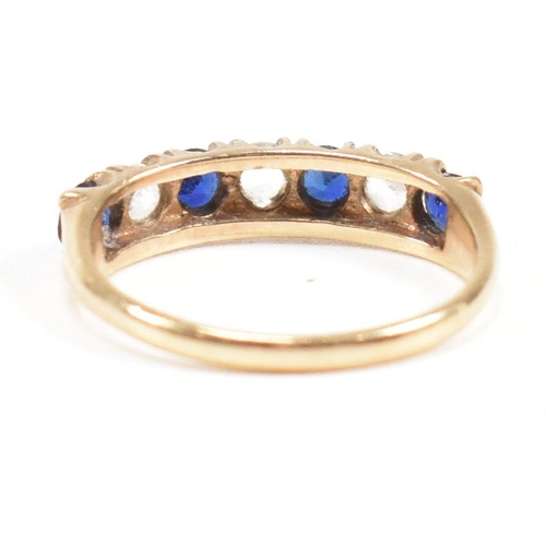 427 - A hallmarked 9ct gold synthetic sapphire and spinel seven stone ring. Weight 2.2g. Size N. All weigh... 