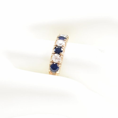 427 - A hallmarked 9ct gold synthetic sapphire and spinel seven stone ring. Weight 2.2g. Size N. All weigh... 